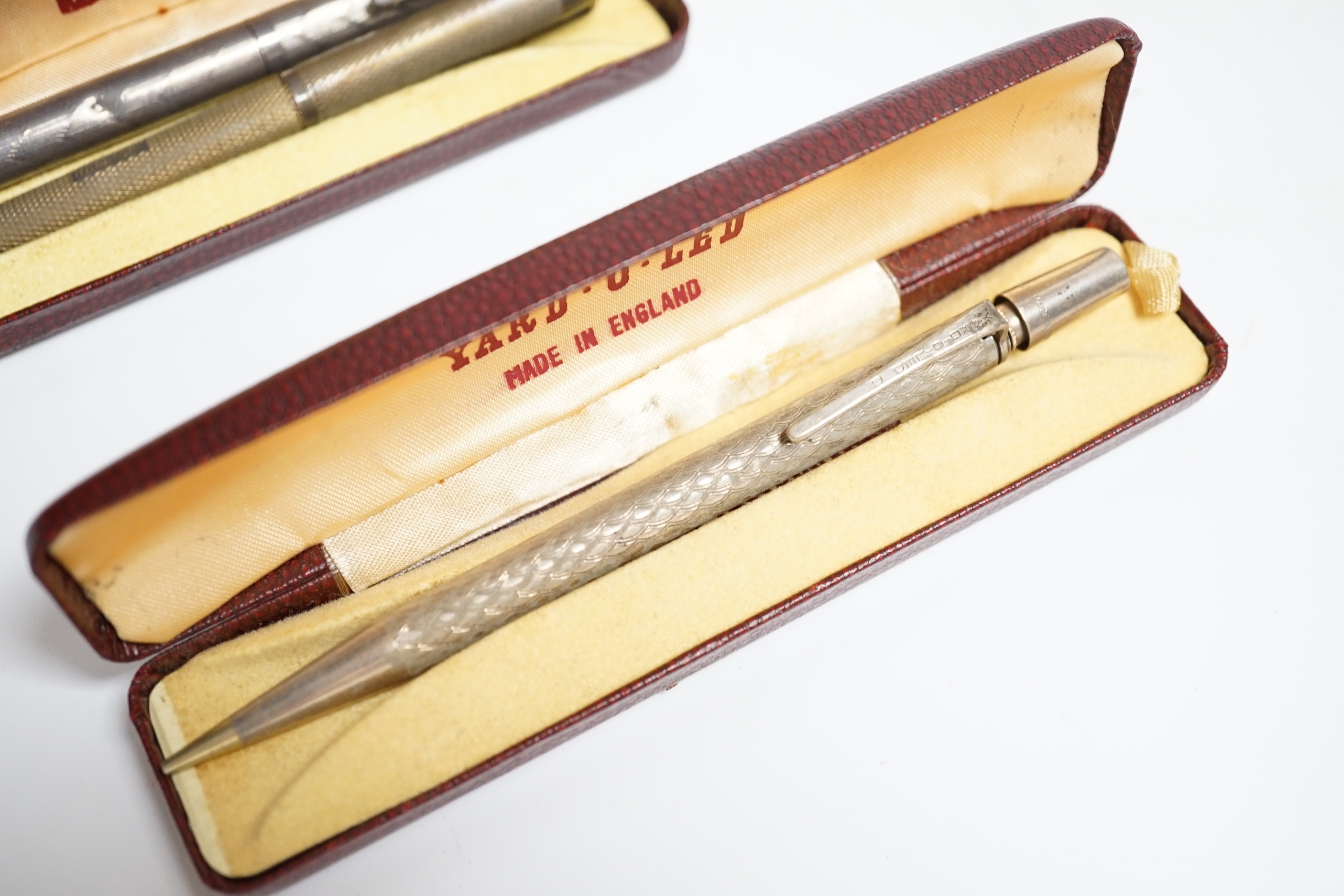 Three Yard O Led silver pencils and two cases